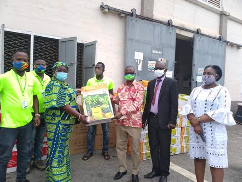 •	MR. AKUAMOAH BOATENG RECEIVING THE KNAPSACK SPRAYERS FROM MADAM GLADYS